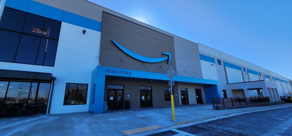 Exterior view of a large building with a prominent blue HMW3 logo above the main entry, symbolizing its commitment to the DC Program.